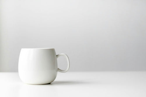 Plain white ceramic coffee mug sample